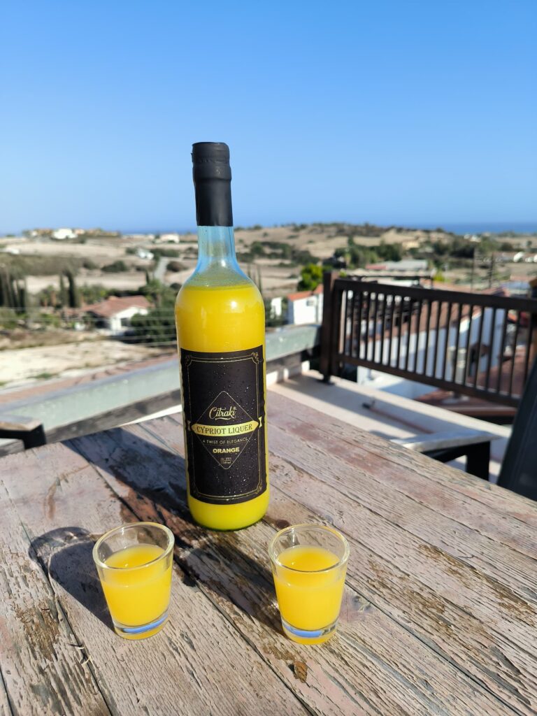 on a table a bottle and shot Citraki orange